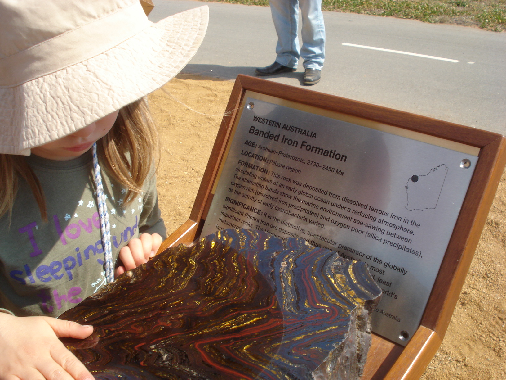 A young visitor admires the polished Banded Iron Formation from the Archaean period in the Pilbara. The Western Australian monolith is still wending its way across the continent but Geoscience Australia stepped into the breach with this stunning specimen to complete the series for the event. 