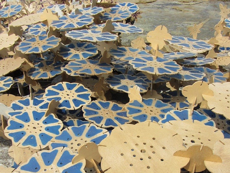 A series of plywood shapes, some painted blue, interlinked to reflect the form of a coral reef.