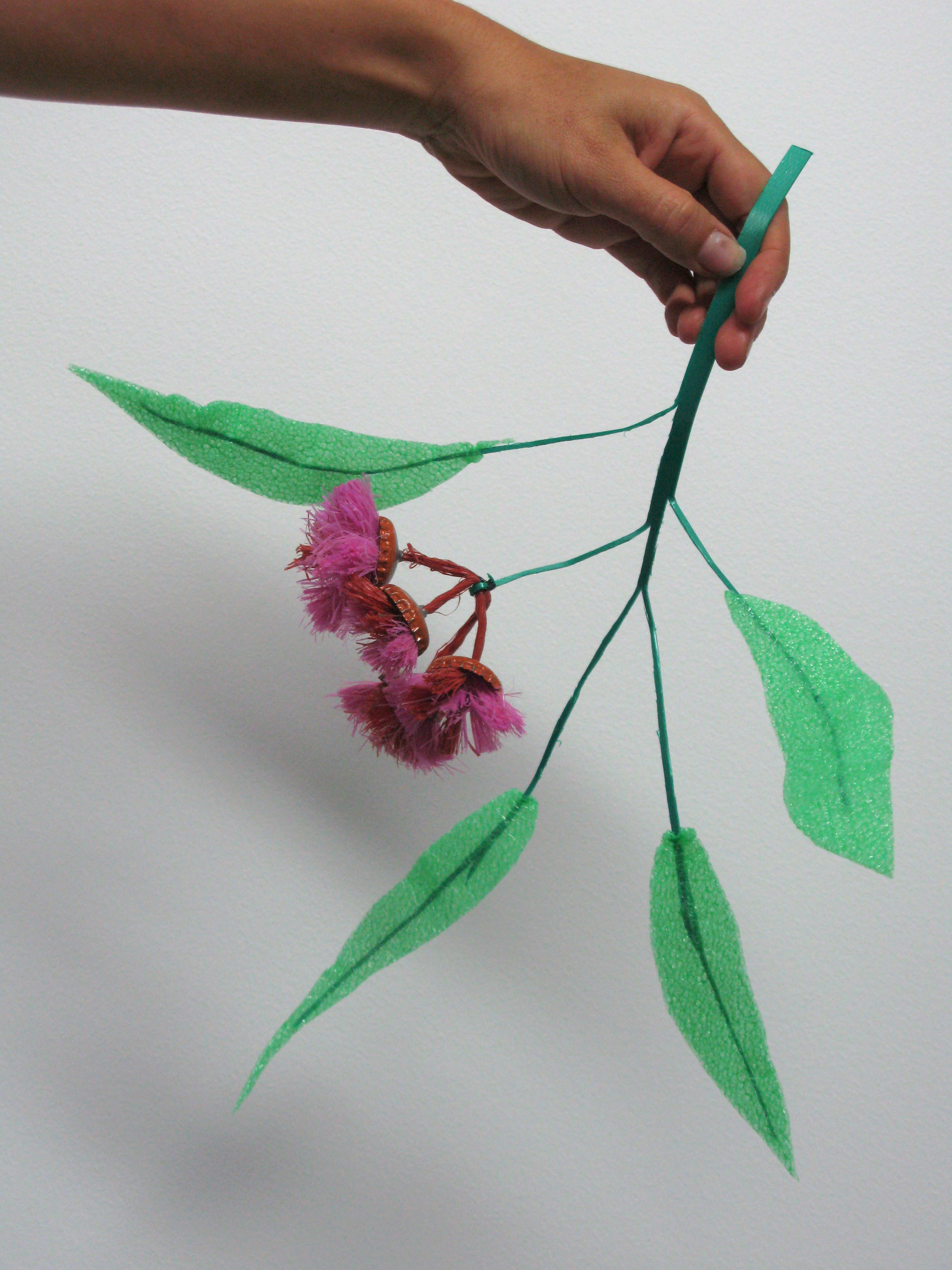 Eucalypt stem of packing strap, leaves of ‘lettuce packing foam’ and blossoms of bottle tops and baling twine. Photo: Bryony Anderson.