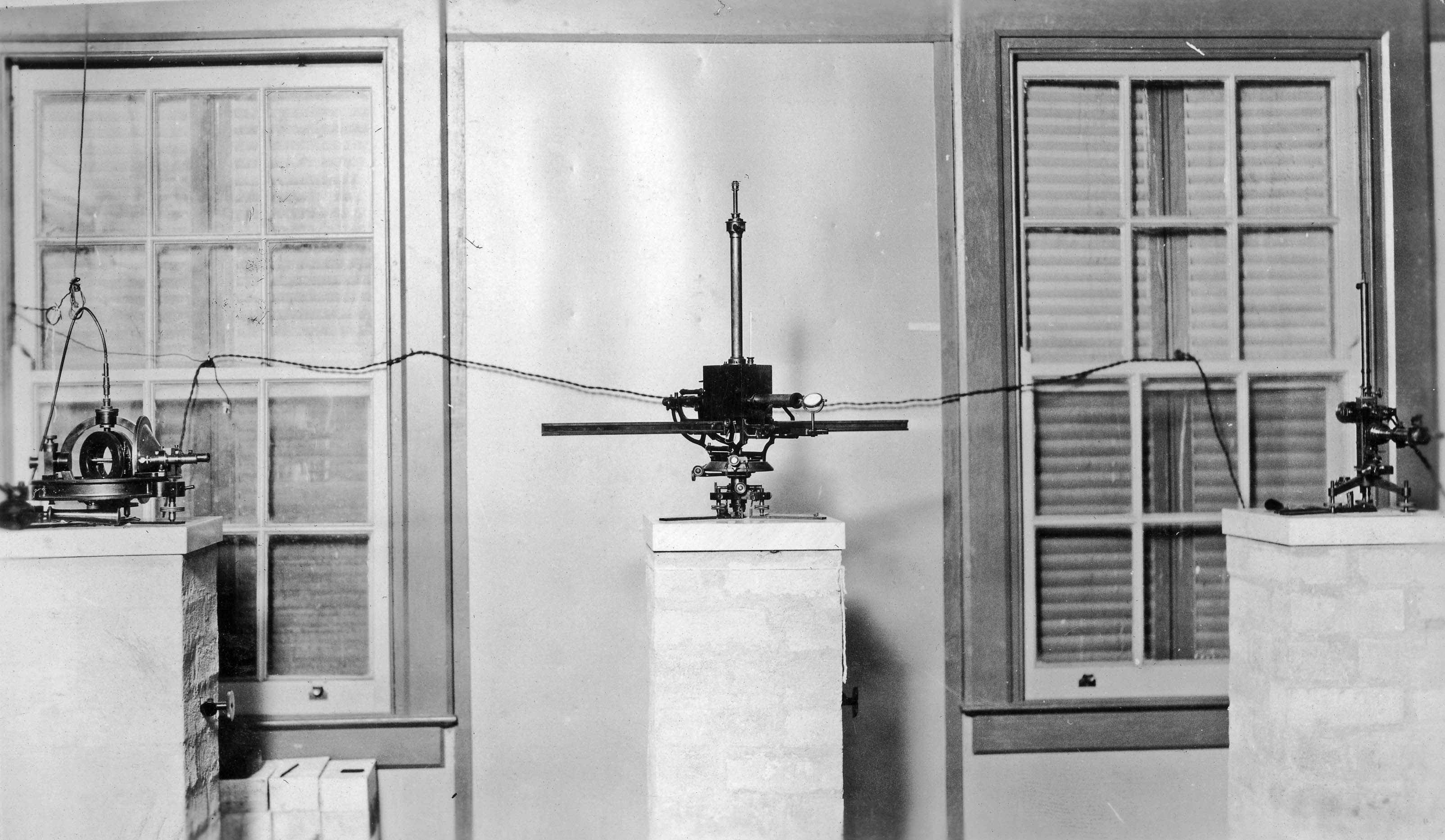 Inside the absolute hut at Watheroo Magnetic Observatory, 25 May 1926. Shows Toepfer earth-inductor, magnetometer CIW-7 and Toepfer mirror galvanometer. All three instruments are now in the National Historical Collection. Image: Carnegie Institution of Washington, Department of Terrestrial Magnetism.