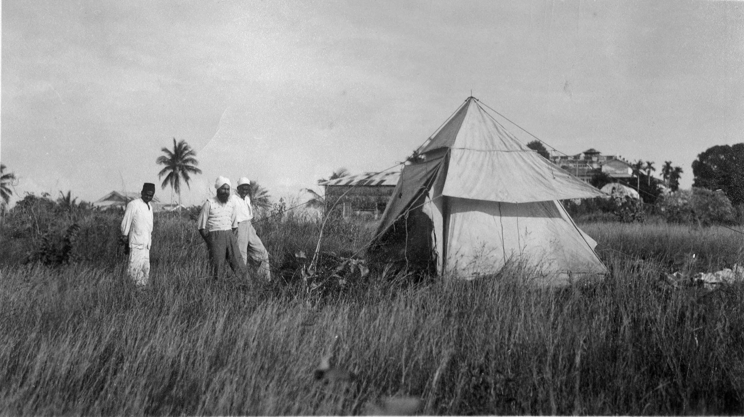 Robert Mansfield's magnetic station at Chukwani on Unguja Island, Zanzibar, 2 October 1934. A contingent of police was needed to control curious on-lookers whilst he established a new station behind the old Sultan's palace. Image: Carnegie Institution of Washington, Department of Terrestrial Magnetism.