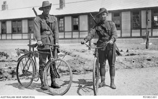 Henencourt, France. 1917-05-12. Two members of the 1st Anzac Cyclists Battalion standing, with their bicycles, in front of their barracks. 827 Private Jack Dair Bambury (left) and 830 Private Herbert (Terry) Davies. Australian War Memorial