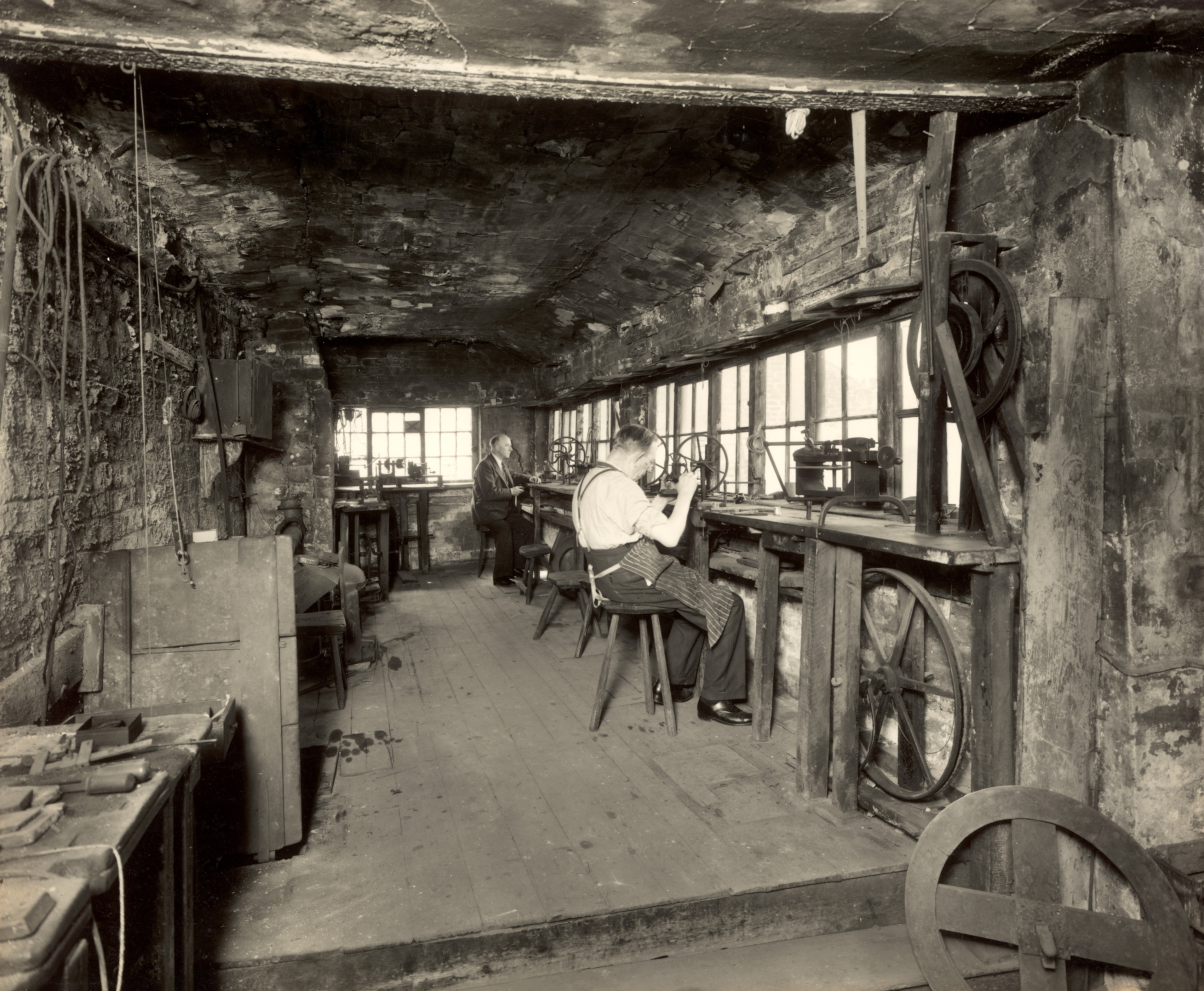 Interior of Joseph Preston's workshop, Eccleston Street, Prescot, 1953. Joseph Preston & Son manufactured watch and marine chronometer movements in these rooms from 1829 until about 1950. Much of the equipment was removed from the shop prior to 1953. Image: Prescot Museum.